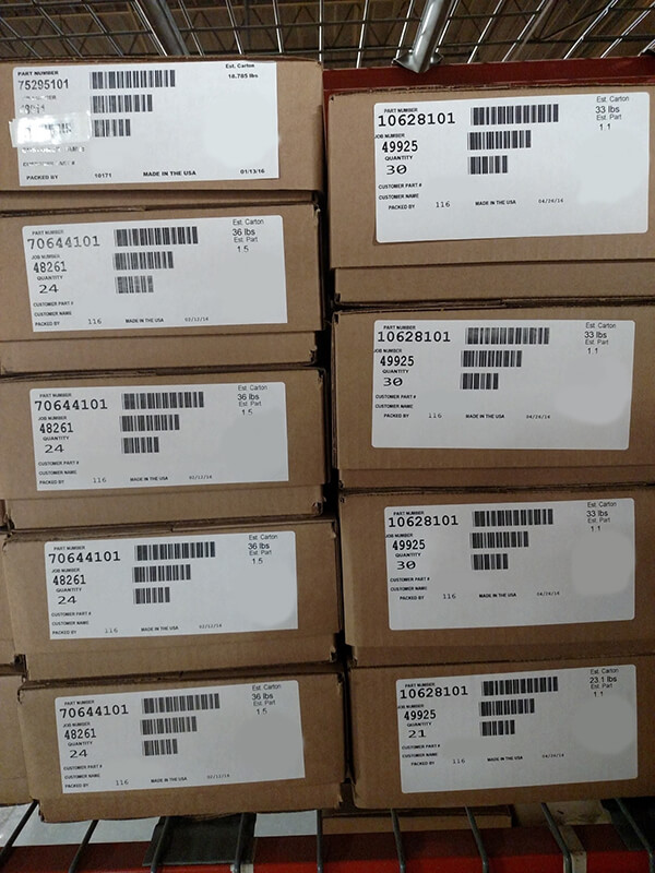 whole stack of boxes with barcode labels ready to be scanned all at once into Epicor